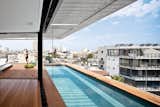 Outdoor, Swimming Pools, Tubs, Shower, Lap Pools, Tubs, Shower, Rooftop, Wood Patio, Porch, Deck, and Large Patio, Porch, Deck The decking on the rooftop is Burmese teak and the colorful Picot pouffes are by Paola Lenti.  Photo 8 of 8 in Modern High-Rise Town House in Tel Aviv