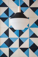The pendant, sourced from Amsterdam Modern, is made from Black spun aluminum and vintage Pilastro Diamond milk glass.  Photo 1 of 3 in Bad by Evelyn Weber from A Bright, Geometric Bathroom Renovation in Los Angeles