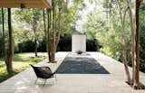 Concrete Box House backyard patio with wood decking and center cutout filled with gravel
