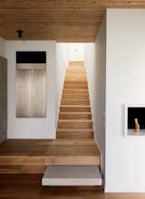 White-oak stairs connect the first-floor living spaces with the upstairs sleeping areas.