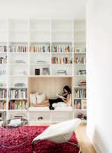 In building their own home in Houston, Texas, design duo Vivi Nguyen-Robertson and Christopher Robertson created a library with white walls and shelving, complete with a wood-lined reading niche—the perfect spot to cuddle up with a good book (and maybe a dog or two).