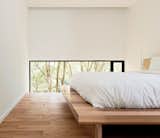The low windows in the master bedroom focus the view on the backyard, not the neighbors. Christopher designed the solid poplar platform bed.