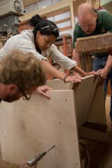 Fahmida gets a little assistance from Thos. Moser craftsmen Adam Rogers and Warren Shaw. Photo provided by Thos. Moser.