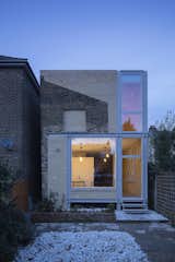 At a London terrace house, Tsuruta Architects undid one rear addition and instituted another that better recalls the home's form and origins. The lighter brick extension mimics its host's sloping gesture.