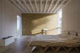 Structural lines are on full display in the bedroom, where ceiling beams and a plywood bed frame catch the eye.  Marcus Brown ’s Saves from An Award-Winning London Addition Balances New and Old