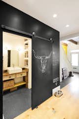 The chalkboard wall also acts as a sliding pocket door to the first floor bathroom. To maximize usable space, there are no hinged doors in the home's interior.