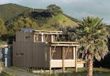 On New Zealand’s Great Barrier Island, two architects designed a petite holiday home that takes care of its own water, electricity, and sewage needs.  Photo 1 of 7 in Small Summer Getaways by Erika Heet