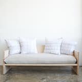 Maple and brass sofa by Farrah Sit and Rebecca Atwood

This sofa—exclusive to WorkOf—was born out of a collaboration between furniture designer Farrah Sit and textile designer Rebecca Atwood. The frame is Sit's; the upholstery Atwood's. "A lot of overlaps exist in their tastes and their styles," Neamonitis says. Photo by Emily Johnston.  Photo 6 of 13 in Throw Pillow Party by Norah Eldredge from WorkOf: Building a Community of Brooklyn Makers