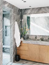 The striking master bath is lined from floor to walls in silvery gray marble.