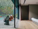 Solid European oak flooring by DuChateau runs throughout the home. The sculpture is by Jorge Yázpik.  Photo 12 of 15 in A Lush Retreat With a Sheltered Rooftop Pool in Mexico City