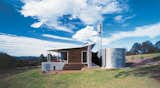 Four tanks collect rainwater, while the southern wall of broken-face concrete blocks keeps the house appropriately cool or warm, depending on the time of year. Photo by Brett Boardman.