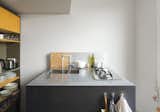 With clever storage and a retractable skylight, a London apartment designed by metalworker and owner Simone ten Hompel and Roger Hynam of Rogeroger Design Solutions feels larger than its 576 square feet. The team worked in a uniquely collaborative way, with Ullmayer Sylvester planning the space, Hynam creating the built-in storage and the kitchen island, and ten Hompel making models and scrawling on the wall to better envision their proposals. The kitchen island features a compact cooktop by Whirlpool and an integrated drainboard incised into the countertop for easy cleaning.