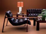 The seat support of the MP-129, designed in 1976, hangs on the upper back beam of its solid hardwood frame.