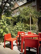 Outdoor, Small Patio, Porch, Deck, and Concrete Patio, Porch, Deck On his patio are a table and chairs from the 1968 Ozoo collection by Marc Berthier for Roche Bobois.  Search “sumo drum table” from This Petite Paris Apartment is a Vintage Furniture–Filled Delight