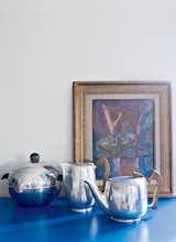 Living Room Antique tea and chocolate pots are juxtaposed with a 1930s painting by Jacques Villon, Marcel Duchamp’s brother.  Photo 6 of 9 in This Petite Paris Apartment is a Vintage Furniture–Filled Delight