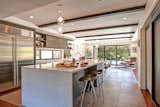 The kitchen’s open concept allows for free-flow of movement through the space. Seating is dispersed between the kitchen and dining area. The stools are from Room & Board. The refrigerator is Sub Zero.