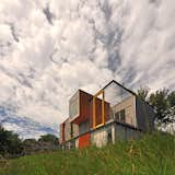 High-efficiency glazing and permeable surfaces on the driveway, entry path, and terrace that facilitate stormwater runoff contributed to the home’s LEED Platinum status. Solar panels produce 80 percent of the power the residence requires.