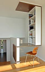 A compact custom desk and shelving system makes the most of the available space.