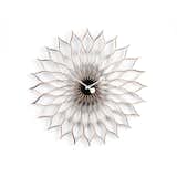 Now considered an icon of mid-century design, the Sunflower Clock is a distinct departure from traditional clocks with faces enclosed in glass—alternatively, the Sunflower Clock is comprised of birch petals, the interior of which include 12 small time markers, instead of a conventionally numbered face. The clock hands are a brilliant white set on a black center, nodding to the seeded center of a sunflower.