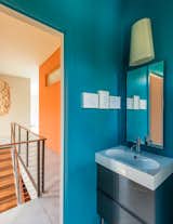 Bath Room and Drop In Sink A Kite wall sconce by Foscarini and mirrors from Gedy by Nameeks are installed above a polished chrome faucet from Kohler’s Purist collection.  Photo 7 of 9 in A Fun, Cost-Conscious Home with Bright Interiors and a Climbing Wall by Tiffany Jow
