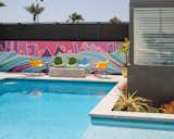 One of the client’s main requests for the home was a large pool to replace the existing asphalt backyard. Artist Nate Schnell painted a second mural in this area to add color and energy.  Photo 6 of 10 in A Dull Stucco Home Becomes a Modern California Oasis