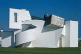 The Vitra Design Museum in Weil am Rhein, Germany, designed by Frank Gehry, 1989.  Search “Touring-Vitra-Campus-Part-1.html” from An Exhibit Tells the Story of Legendary Design Brand Vitra