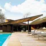 The Babat residence in Nashville is blessed with a big backyard; however, the blistering Tennessee sun once made it feel more like a broiler than a place to kick back and relax. Enter architect Michael Goorevich, who devised a wood-and-steel trellis to cover part of the space.  Photo 4 of 27 in Pools to Dive Into by Kate Gregory