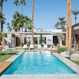 Architect Sean Lockyer designed a 5,760-square-foot concrete, stucco, and ipe home for a couple and their three children in the Southern California desert town of Indian Wells. The residents selected the home’s furnishings, including the Royal Botania chaise lounges. A covered patio, with a fire pit and bar, sits next to a 60-foot swimming pool.
