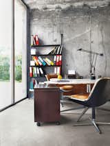 Office Outfitted with Pollock desk chairs and a marble-topped conference table by Knoll, the office in Monory’s French farmhouse pays homage to international design. The Tizio task lamp is by Richard Sapper for Artemide, and the leaning John Ild bookshelf was designed by Philippe Starck for Disform in 1977.  Photo 9 of 12 in Matali Crasset Renovates Monory Farmhouse