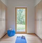 The exercise space contains ample storage and a convenient door for days when the couple wants to practice yoga outdoors. The blue Frank Gehry Left Twist Cube adds a pop of color to the space.