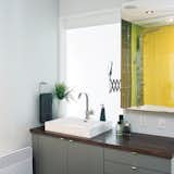 When it came time to renovate this windowless bathroom in Montreal, the design team replaced a section of the wall with yellow acrylic to brighten it up.  Photo 3 of 9 in Tile Ideas To Upgrade Your Home  by Kate Gregory