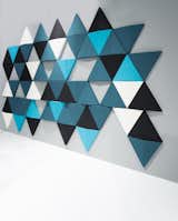 Connected panels of molded polyester fiber, covered with fabric, make up the sound-absorbing Bits wall by Abstracta. The triangular shape of the panels helps break the sound waves, making the design ideal for an office environment.