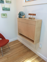 "We used magnets to hold everything closed to keep things looking clean. The first small fold is important, as it acts as a spacer to keep the top of the desk level as it sits on the fold-out supports underneath."