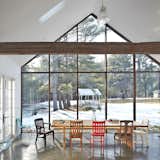By removing two bays in the back of a 19th-century home in Eldred, NY, a self-taught designer was able to erect a 22-foot portal made of skyscraper glass.  Photo 7 of 8 in Homes with Unusual Windows by William Harrison from Massive Windows With Maximum Impact