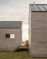 Exterior, Cabin Building Type, and Wood Siding Material Sited parallel to each other, the two autonomous bedroom cabins frame perspectival views of the surrounding landscape. Exteriors of all three structures feature mitered corners and cross-laminated timber panels, all nailed by hand.  Photo 11 of 14 in Farmhouse by Niklas Stüczen from A Cluster of Cabins in a Former Quarry Makes a Simple Vacation Escape