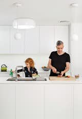 Brightening the kitchen was a renovation priority. The cabinets are custom, the sink is by Kohler, the ceiling lamp is Jasper Morrison’s Smithfield C for Flos, and the Castore pendants are by Artemide.