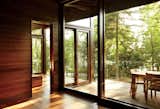 Windows, Wood, and Sliding Window Type Douglas fir-framed windows by Dynamic Architectural Windows & Doors offer layered indoor-outdoor views.  Photo 1 of 27 in Custom small house by Matthew Capps from Frank Lloyd Wright-Inspired Style and Camping Collide in Maine