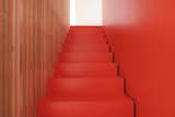 The stairs are coated in orange lacquer.