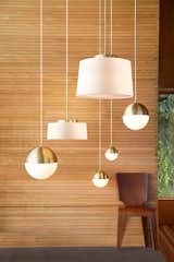 Living Room, Pendant Lighting, and Chair The collection combines influences from modernism and the Arts and Crafts movement. The Cedar & Moss pendants with a brushed satin finish are shown here.  Photo 3 of 7 in Classic Modernist House in Portland Inspires a Lighting and Furniture Line