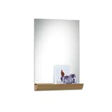 Designed by Andrea Stemmer for SCP, the Jules Mirror is an unframed, rectangular portrait mirror that works well in an entryway or above a bureau or vanity. The mirror features a solid oak storage shelf at its base, which can be used to hold knickknacks, makeup, keys, or favorite photographs and postcards.