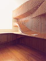 When a London homeowner contacted architect Alvin Huang about building him a sleek and sculptural built-in desk, Huang and his team got creative, hanging sheets of fabricated milled birch to produce a sinuous three-dimensional form. Look closely and you can see the five hidden cabinets that conceal files, books, a phone, and a paper shredder. Additional inset horizontal spacers form an abstract world map and double as a means of holding the boards in place.