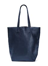 This classic leather tote from Baggu makes a luxe book bag, commuter bag, or everyday purse. Available in rich mahogany and navy, the bag will complement casual and elegant outings alike.