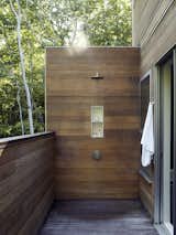 A wood-lined outdoor shower adds a modern touch to one of the decks.