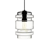 From Niche Modern, the Delinea Glass Pendant Light is a sculptural glass hanging light. Made of hand-blown glass, the Delinea is available with a tubular incandescent bulb, but can be paired with a Plumen 001 Bulb (as shown) to create a striking look that celebrates both the sophisticated glass shade and interior illumination.