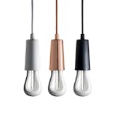 The Plumen Drop Cap Pendant Set was designed to coordinate with the Plumen 001 bulb, and also supports the smaller Plumen 001 Baby and Plumen 002 (shown). The Drop Cap contains an interior screw fixture and covers the upper part of the bulb, creating a simple and elegant frame of the glass tubes of the bulb. The Plumen 002 mimics the shape of an incandescent bulb, while adding a sculptural, sophisticated slant.