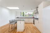 The clean-lined kitchen is the focal point of the addition. The new configuration clearly delineates McBreen and Russell's public and private quarters, with bedrooms occupying the original structure.