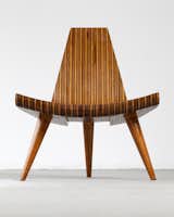 Widely consider the first modern master of Brazilian design, Joaquim Tenreiro created many timeless classics. His contribution to Brazilian design is evident by his designs that made hardwood furniture sleeker and lighter. Tenreiro’s 1947 Three-Legged chair was laminated in multiple woods that included native species such as imbuia, roxinho, jacaranda, ivory, and cabreúa. In this example, the chair is made in five different types of hard wood, with bonded laminated. The chair celebrates the material with its inventive form and combinations of wood.