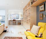 Custom birch millwork, fabricated by Toronto's Gibson Greenwood, defines a home office space on the second floor. Susan brought the yellow couch at right when she emigrated from Hungary in 1969.