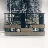 On display at Resource Furniture's booth, the La Literatura shelving system and a ConcreteWall covering adorned with a serene photograph of the Norwegian forest.