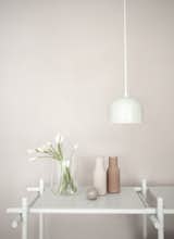 The smaller GM 15 Pendant Light is made of powder-coated lacquered stainless steel. The minimalist, classic pendant light hangs from a white fabric cord. It can be used on its own, or grouped with other GM Pendant Lights.

Shown with Menu’s Bottle Grinders Set.